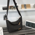 Large black water-resistant nylon messenger bag with adjustable strap and leather trim - Black