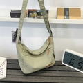 Water-resistant light green nylon messenger bag with adjustable strap and large capacity - Green