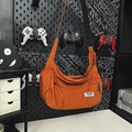 Orange nylon crossbody hobo bag with adjustable strap and side drawstring pocket - Orange