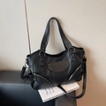 Black pebbled leather tote bag with silver star rivets and adjustable shoulder strap - Black