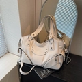 Creamy white studded motorcycle bag in lychee leather featuring silver star rivets - Off White