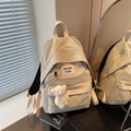 Minimalist beige nylon backpack with plush bear charm and spacious multi-pocket design - Cream White With Pendant