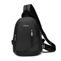 Close-up of black nylon crossbody bag featuring silver metal logo and zip compartments - Black