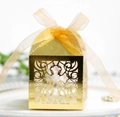 Detail of laser-cut hollow cross gold gift box with an elegant shimmering silk ribbon - Reflective Gold