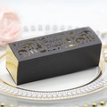 Elegant black and gold Happy Diwali gift box with laser-cut patterns on a ceramic plate - Black