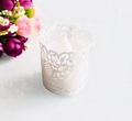 Intricate laser-cut white floral tea light sleeve with glowing LED candle decor - White