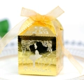 Detail of laser-cut gold wedding favor box with a couple silhouette and ribbon handle - Reflective Gold