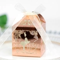 Detail of rose gold laser-cut favor box with kissing couple silhouette and white ribbon - Reflective Rose Gold