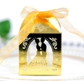 Detailed laser-cut gold wedding favor box featuring silhouette and elegant ribbon bow - Reflective Gold