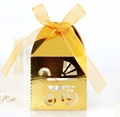 Close-up of golden hollow baby stroller gift box with a yellow ribbon bow decoration - Reflective Gold