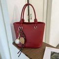 Red pebbled leather bucket bag with braided handle and baseball glove charm - With Pendant / Red