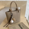 Brown litchi grain bucket bag with a knotted handle and baseball glove charm - With Pendant / Brown