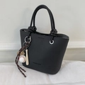 Classic black bucket handbag with lychee texture and sporty baseball charm accessory - With Pendant / Black