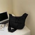 Detail of black nylon dumpling bag featuring dual zippers and adjustable shoulder strap - Black Small