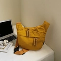 Minimalist amber nylon dumpling bag featuring a woven rope zipper and wide buckle strap - Yellow Small