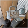 Close-up of light blue denim bucket bag with quilted texture and silver heart lock - Blue (With Pendant)