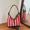 Red and white striped knit tote bag with black leather handles and drawstring closure - Red