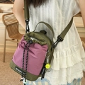Olive green and purple checkered drawstring crossbody bag with tennis ball charm - With Charm / Green and Purple