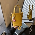 Fashionable bright yellow bucket bag with heart pendant and woven strap details - Yellow with Pendant