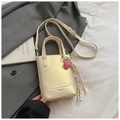Chic beige bucket bag with top handles, crossbody strap and a pink heart charm - Pearlescent White With Pendant