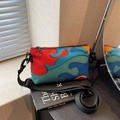 Crossbody bag with colorful abstract wave pattern and adjustable black fabric strap - Colorful