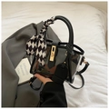 Detail of translucent black bucket bag with gold lock and checkered silk scarf handle - Black