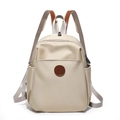 Detail of beige nylon backpack with brown leather logo patch and front zipper pocket - Off-white