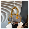 Close-up of denim mini bag featuring yellow leather trim and a silver star charm - With Charm / Yellow