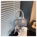 Detail of denim Boston bag with silver star charm and metallic leather trim detailing - With Charm / Silver