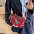 Red embroidered crossbody bag with white dragon patterns and red horse pendant - Burgundy