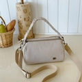 Beige pleated nylon crossbody bag with dual zippers and adjustable wide shoulder strap - Off-white