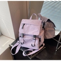 Detail of lavender canvas backpack showing buckle closures and side storage pocket - Purple