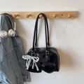 Black patent leather shoulder bag with heart pocket and pearl lace bow charms - Black