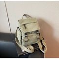 Detail of light green nylon backpack with flap buckles and adjustable beige wide strap - Green