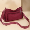 Quilted nylon crossbody bag in deep wine red with adjustable strap and multiple zip pockets - Burgundy