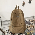 Large khaki canvas backpack with zipper front pocket and MACHUGE brand logo on shelf - Khaki