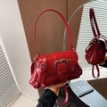 Glossy red saddle bag featuring dual silver heart buckles and a polished patent finish - Red