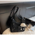Detail of black pleated hobo bag with silver zippers and cute white cloud plush charm - Black