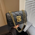 Black quilted chain bag with gold hardware and classic turn-lock closure in variant - Black