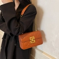 Quilted crossbody bag in orange brown with gold chain strap and geometric metal lock - Brown