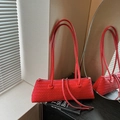 Red woven leather baguette bag with slender shoulder straps and chic textured finish - Red