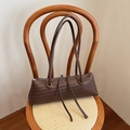 Minimalist dark brown woven leather underarm bag with double handles and tassel detail - Brown
