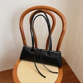 Minimalist black woven leather baguette shoulder bag with slim straps and metal hardware - Black
