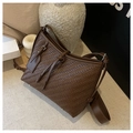 Detailed view of dark brown woven leather texture with silver hardware on shoulder bag - Brown