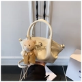 Detail of off-white crocodile texture handbag with cute brown plush bear charm - White with Pendant