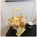 Detail of yellow crocodile pattern bucket bag with cute bear plush charm and round handle - Yellow with Pendant