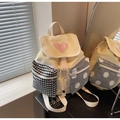 Detail of multi-pattern front pockets and heart patch on cream canvas backpack - Yellow