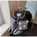 Detail view of large capacity backpack featuring unique black and white patterned front pockets - Black