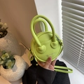 Mini round crossbody bag in neon green pebbled leather with top handles and star pattern - Green