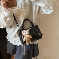 Minimalist black glossy crossbody bag featuring silver turn-lock and plush bear charm - Black with Pendant